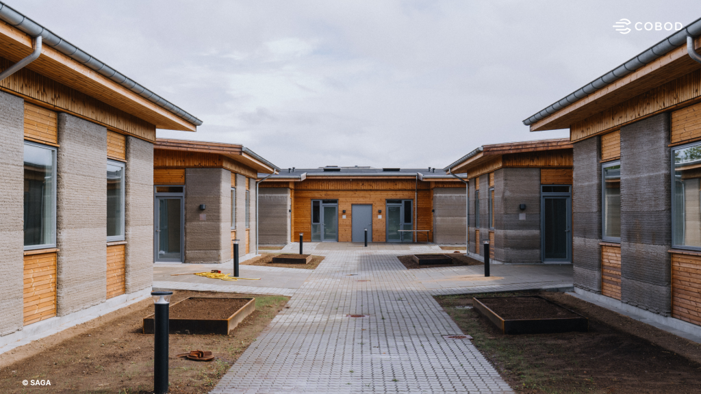 The buildings arranged around a shared courtyard with paths and planting beds