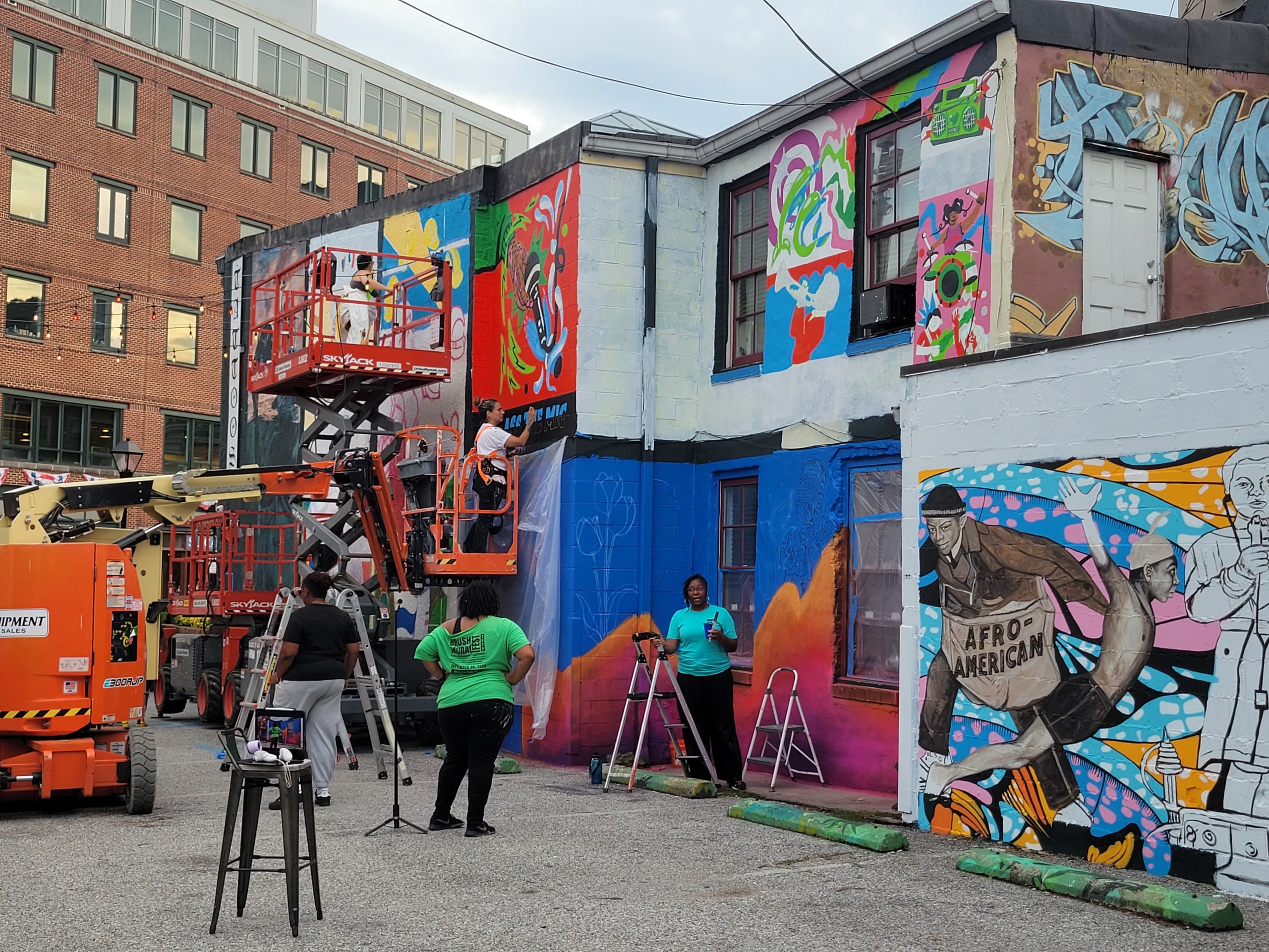 BRUSH Mural Fest artists at work in Baltimore's Fells Point