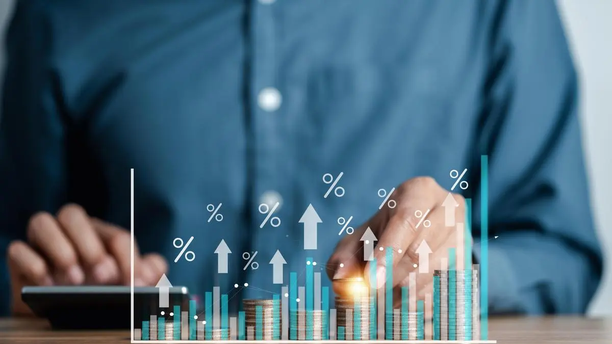 Stacked coins and growth chart illustrating investor interest in premium D2C brands