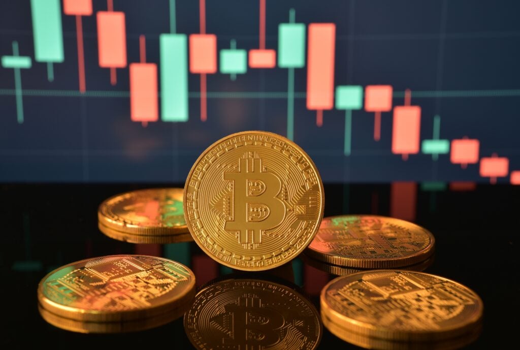 Bitcoin coins on reflective black surface