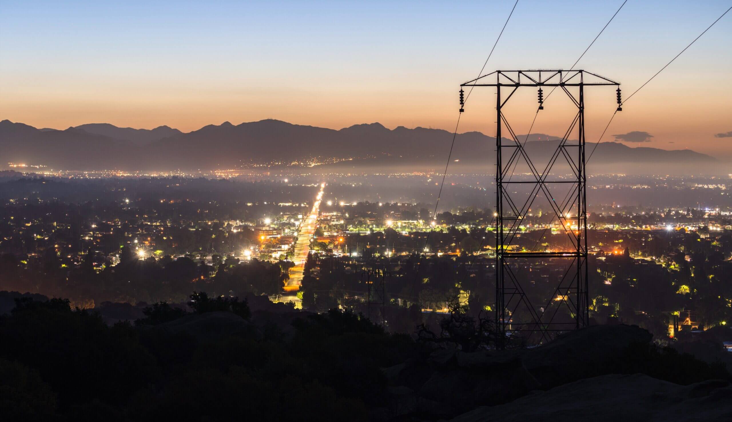Sunset over power lines, representing U.S. clean energy infrastructure funding