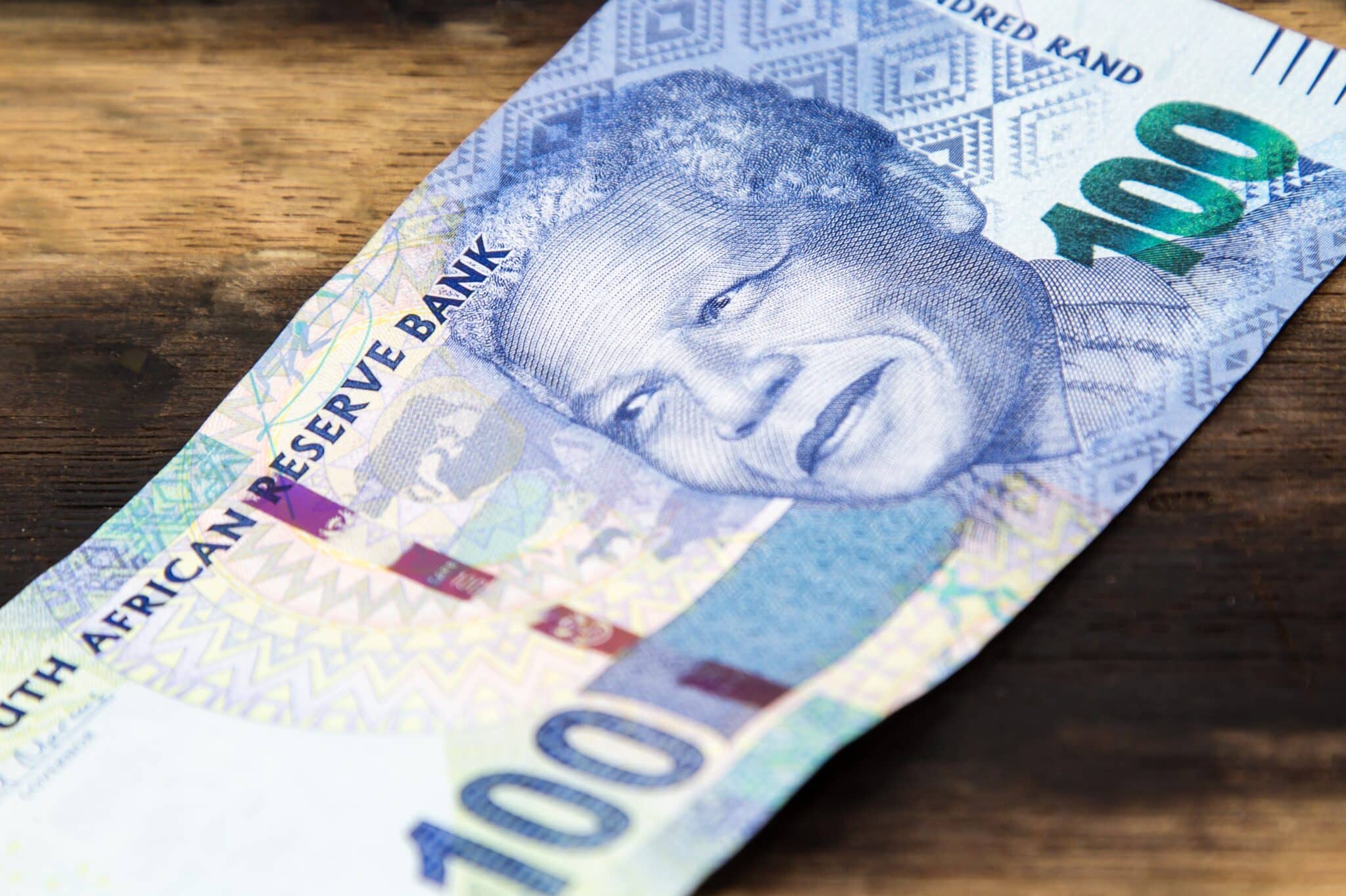 South African rand bill on a wooden surface