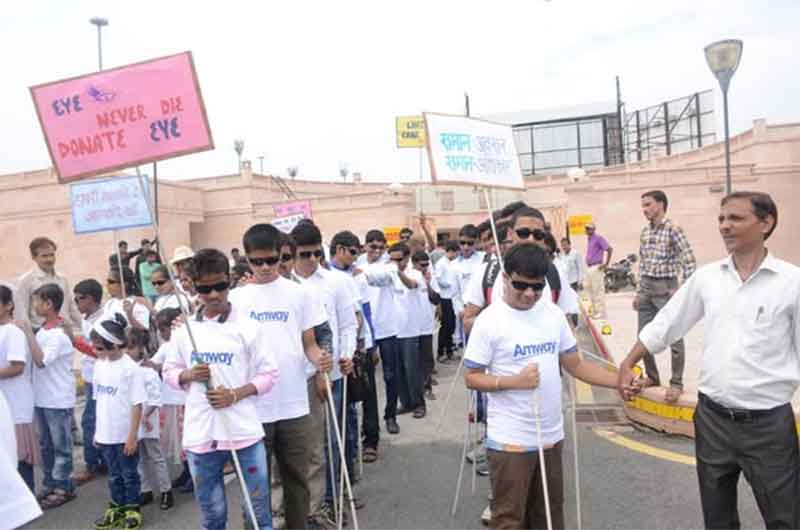 Person using a white cane, symbolizing India's disability community