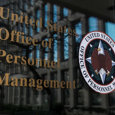 Federal employees walking past the OPM building