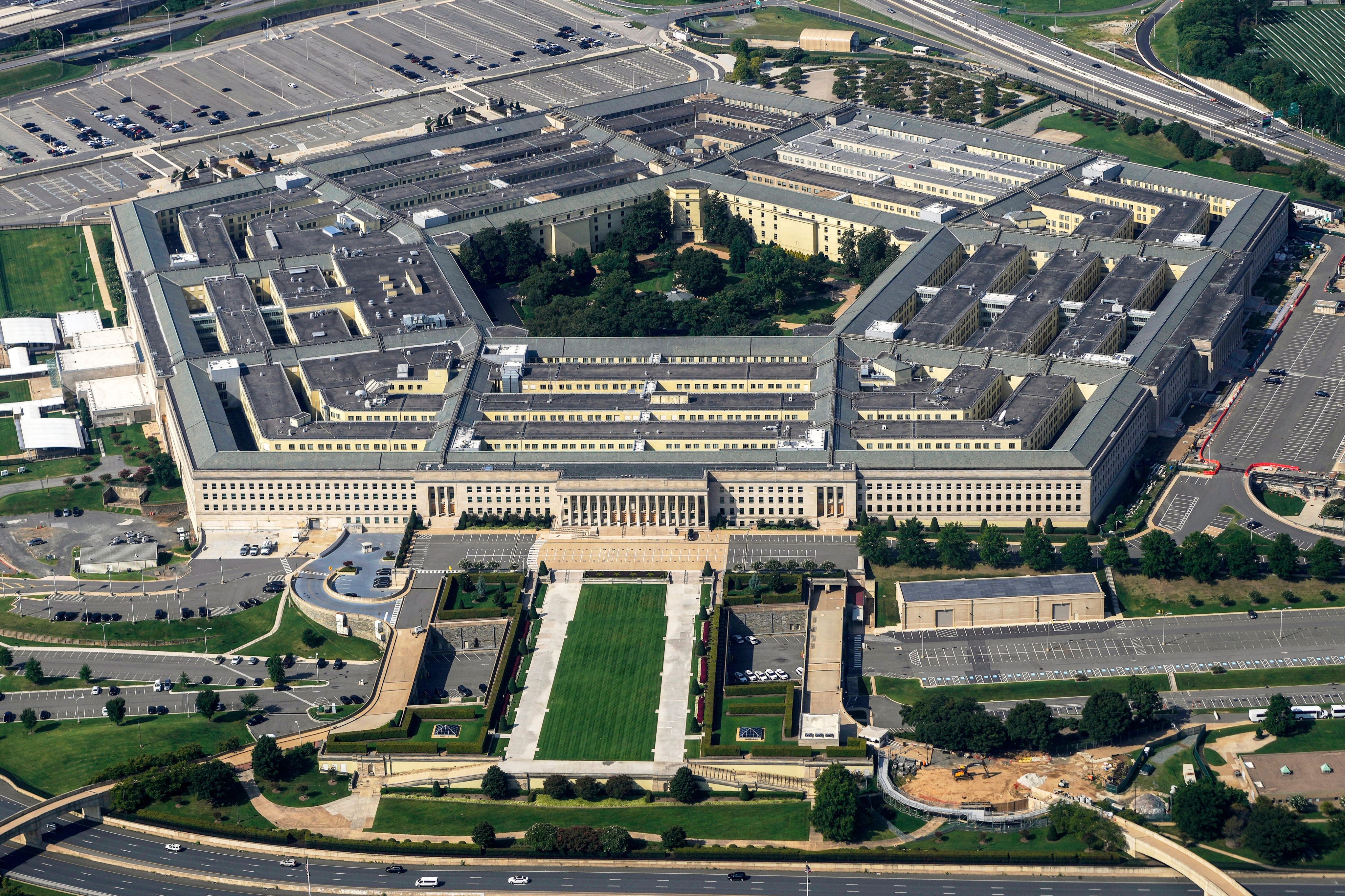 Chinese tech executives at a technology conference; Pentagon military designation impacts reputation and capital access