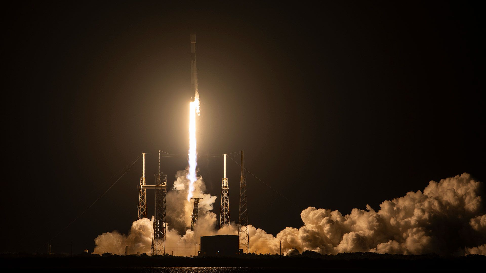 SpaceX Falcon 9 rocket liftoff at night carrying classified NRO payload