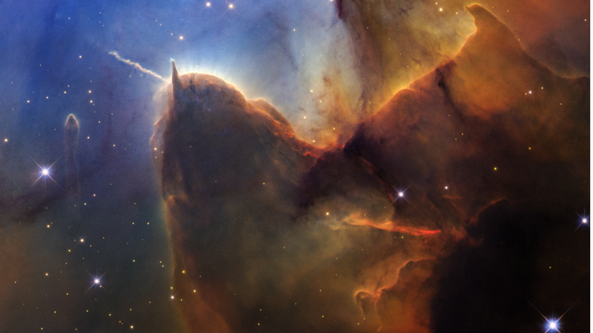 New Hubble Space Telescope image of the Trifid Nebula, showing its glowing gas clouds and dark dust lanes in vivid detail