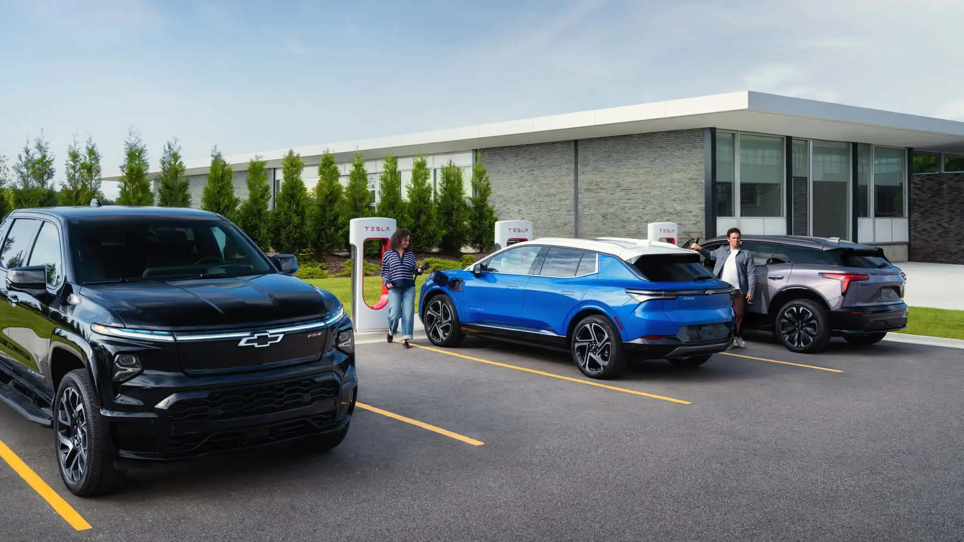 GM electric vehicles charging at Tesla Supercharger network