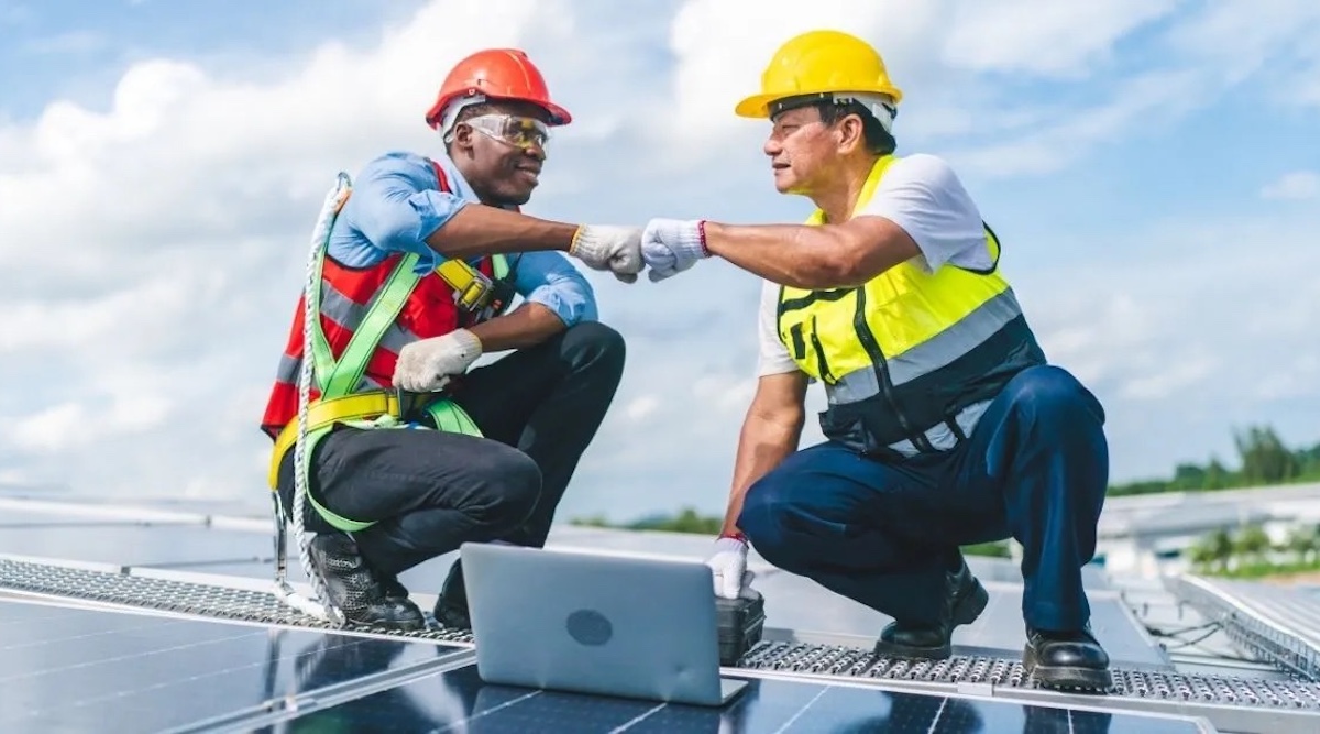 Solar energy installation crews working on residential rooftop system