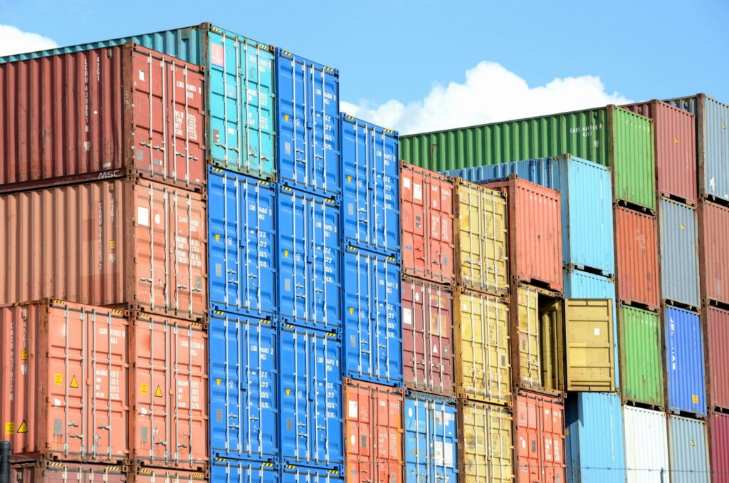 Cargo vessel and container ship at port showing container logistics operations