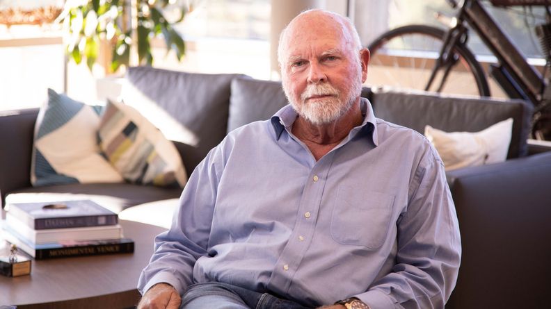 J. Craig Venter seated, the pioneering genomics scientist who died at age 79