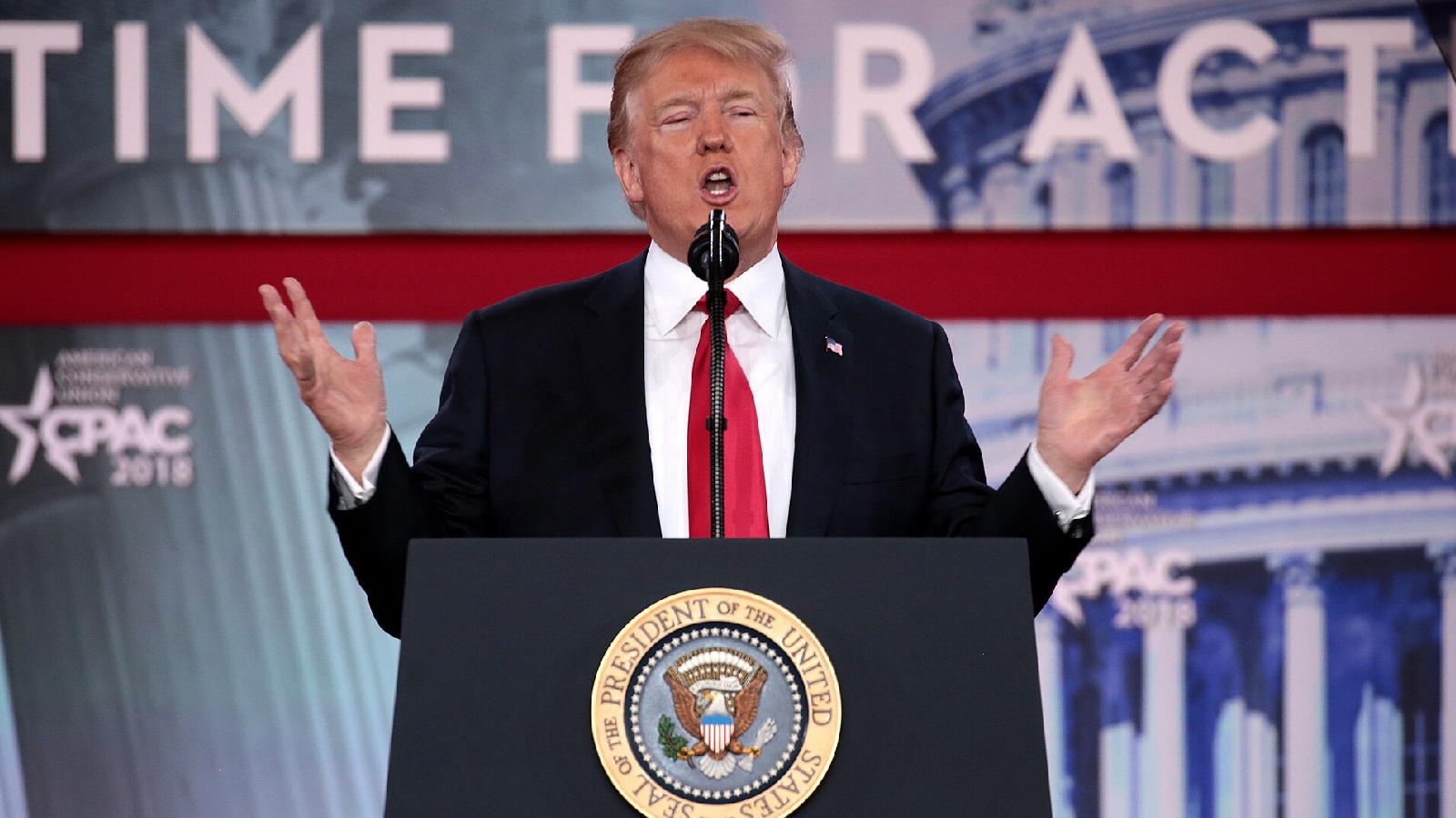 Donald Trump speaking at a podium
