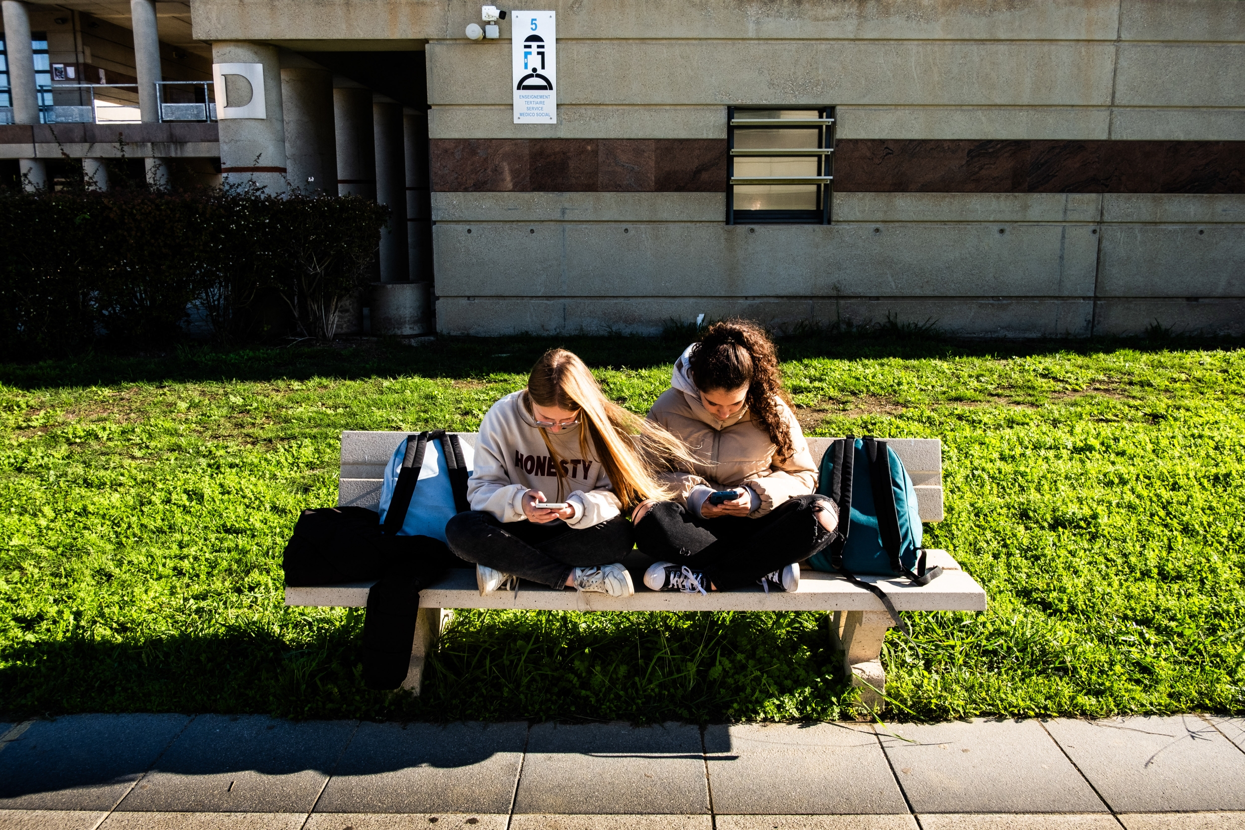 Teenagers using smartphones, illustrating the persistence of social media access despite bans