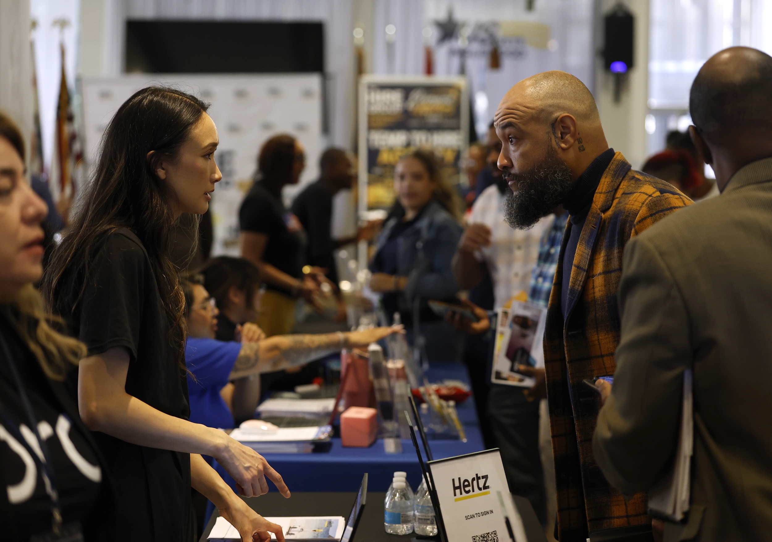 A job seeker meets a recruiter — tech hiring and firing are both accelerating in 2026's bifurcated market