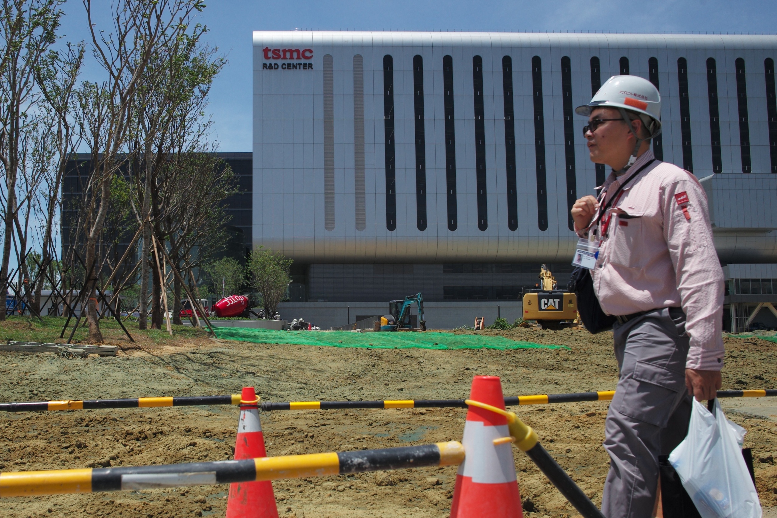 Worker walks past construction site of Taiwan Semiconductor Manufacturing Company