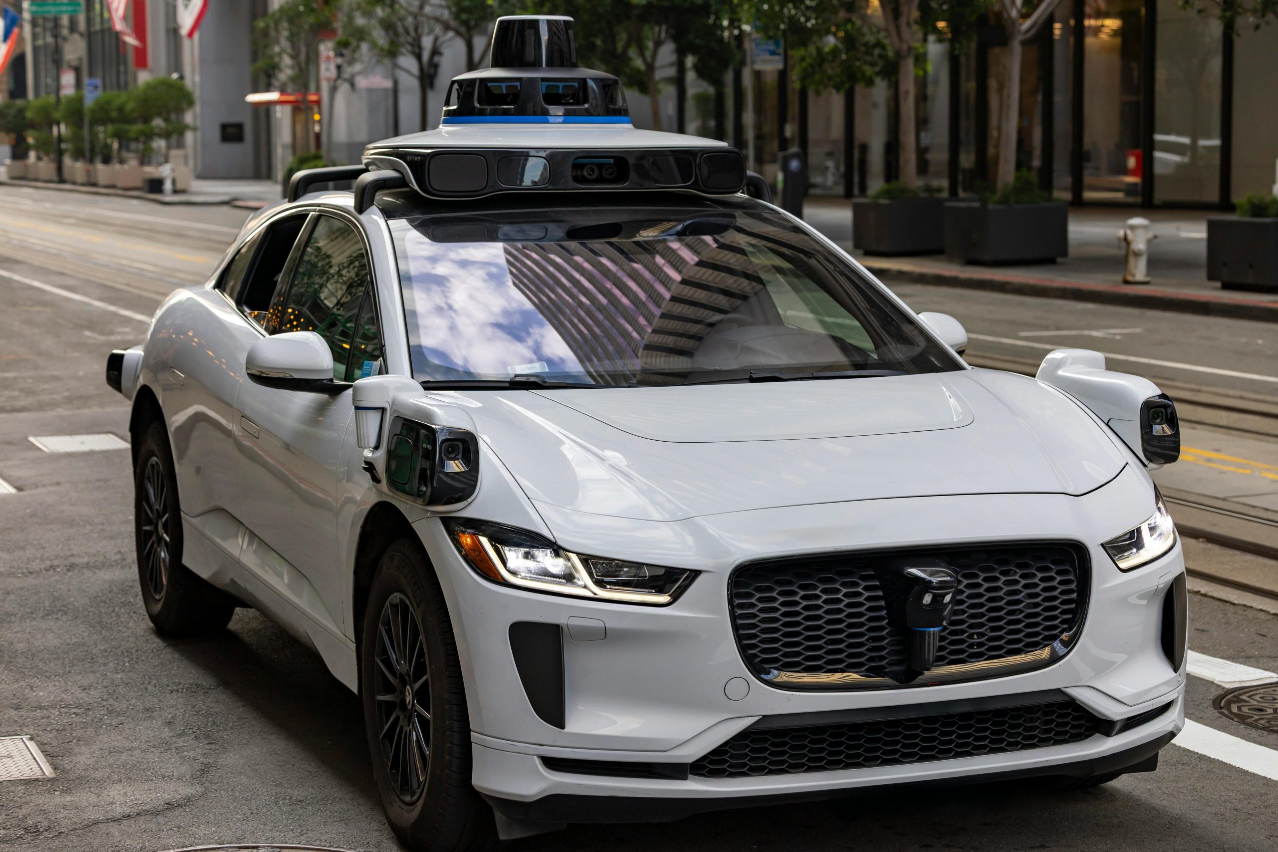 A Tesla autopilot vehicle on a road illustrating autonomous fleet insurance