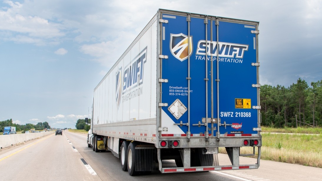A Swift tractor-trailer on a U.S. highway, representing the truckload carrier sector facing Q1 headwinds