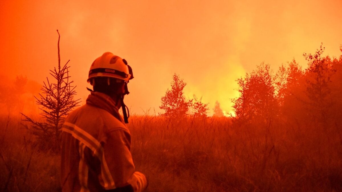 Firefighter battling wildfire amidst extreme heat