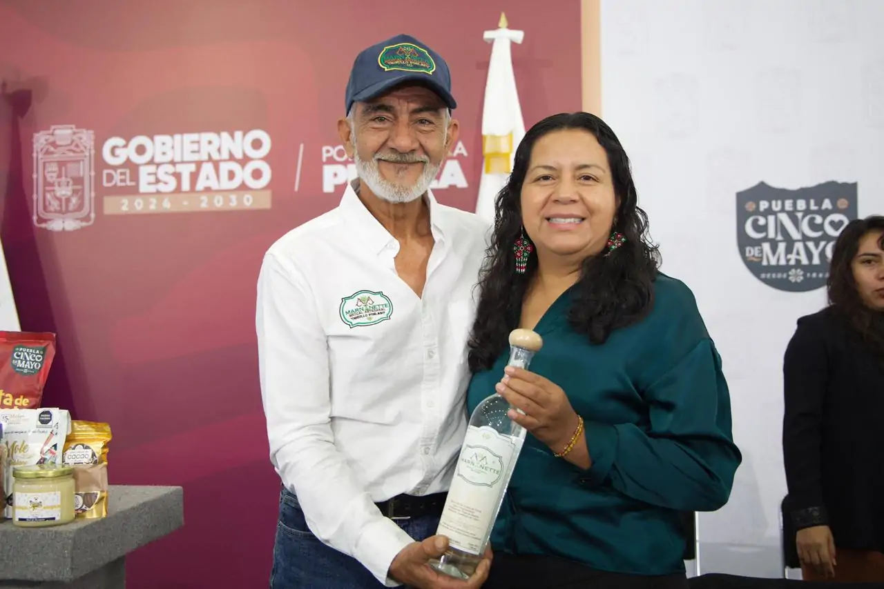 Puebla mezcal producers celebrating success at a national competition.