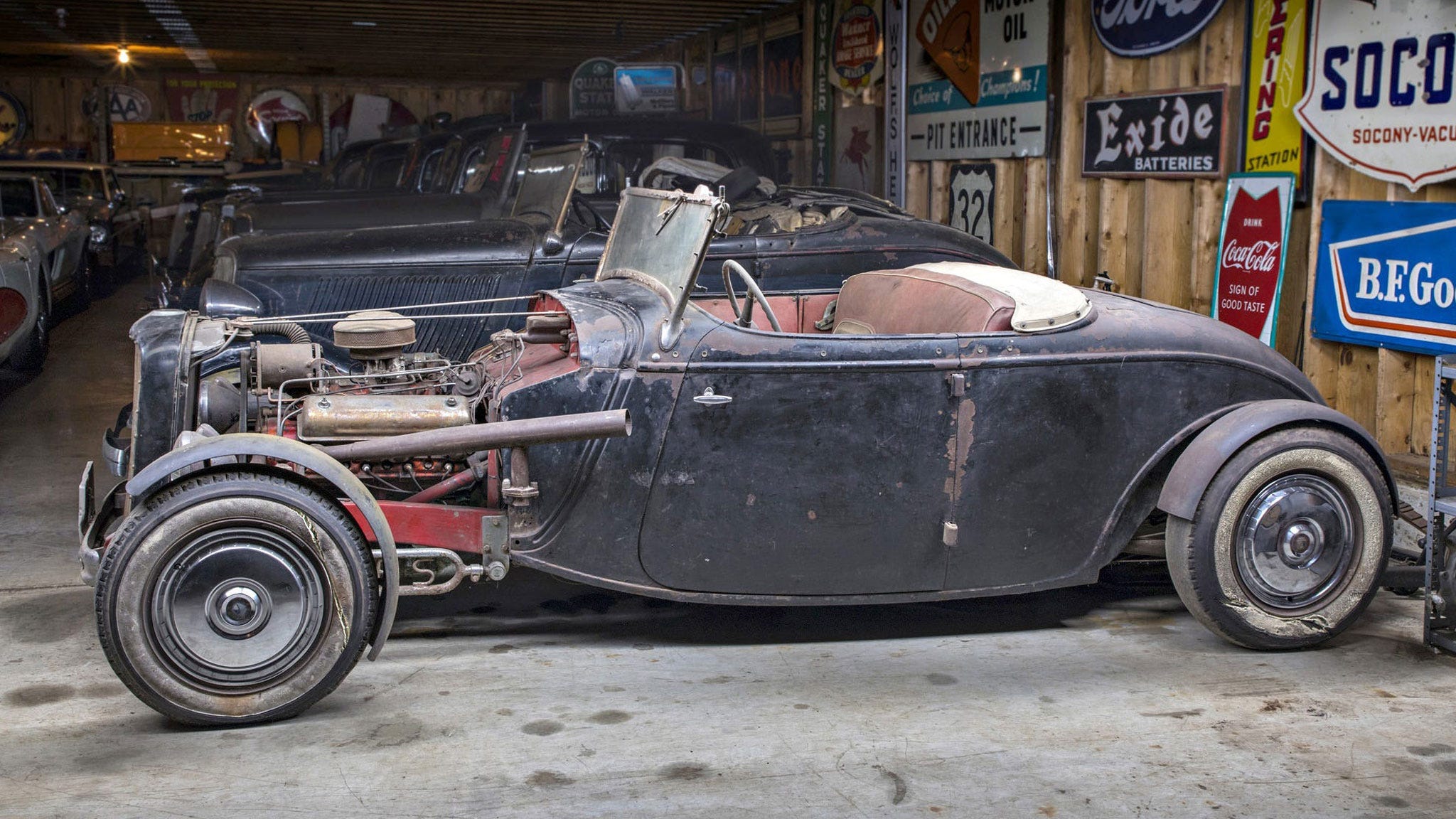 Prewar classic automobile undergoing restoration, showing extensive documentation and parts challenges