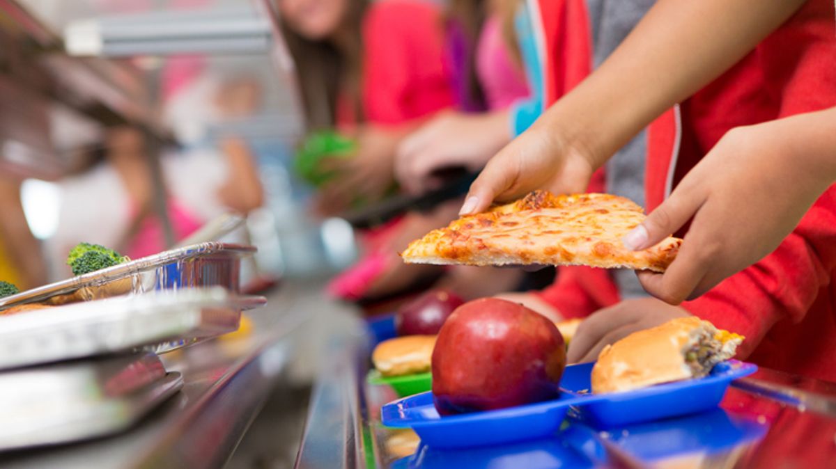 School children getting food in the cafeteria line