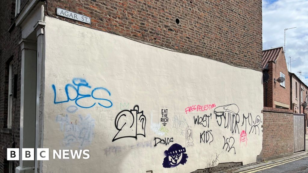 Graffiti-tagged wall at 54 Monkgate, York
