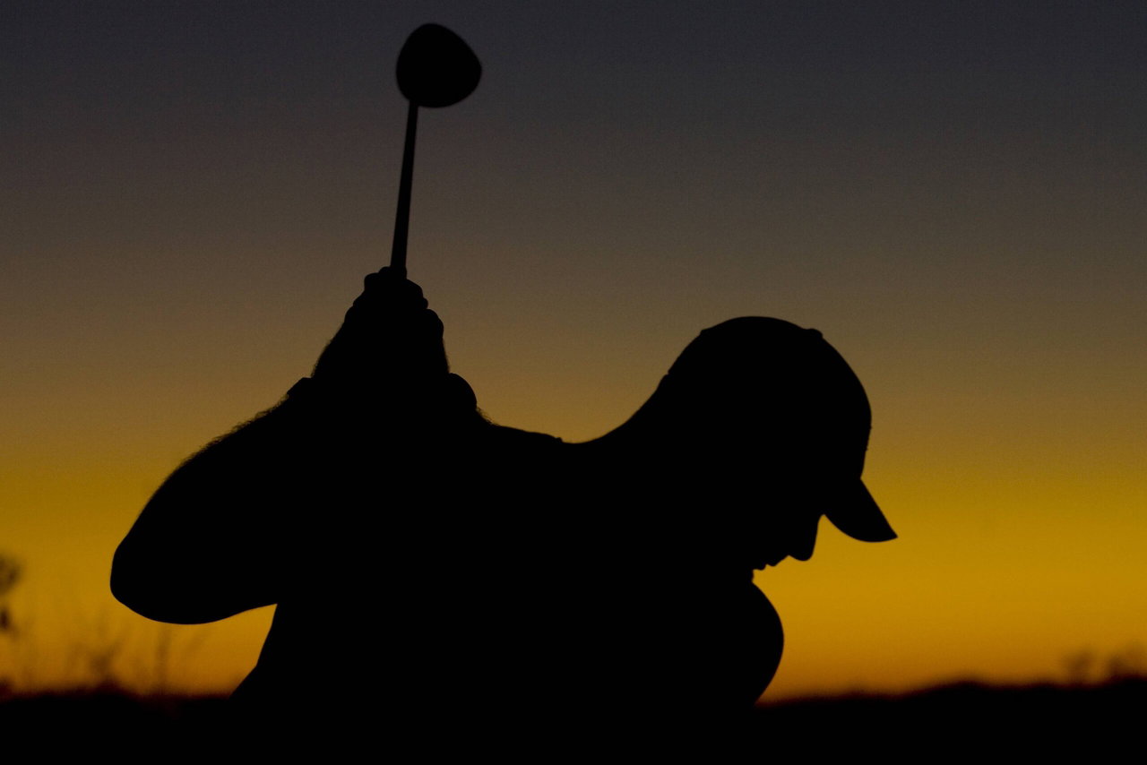 Silhouette of a male golfer, illustrating the tension between traditional tours and former LIV players