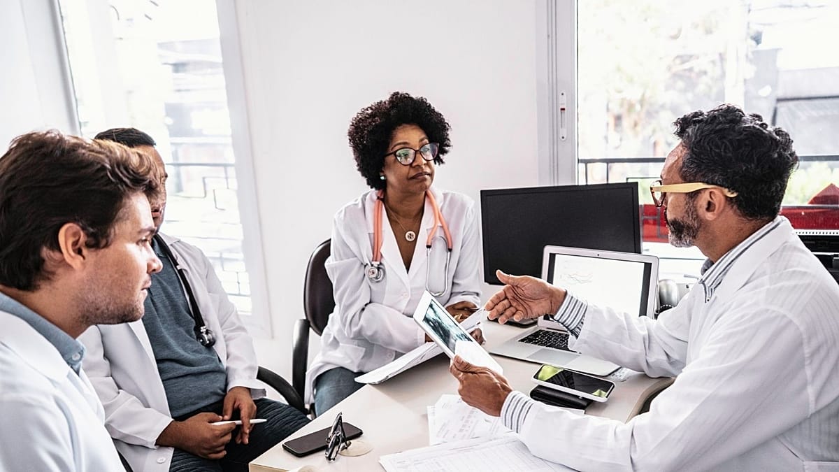 Healthcare professionals working with AI interface