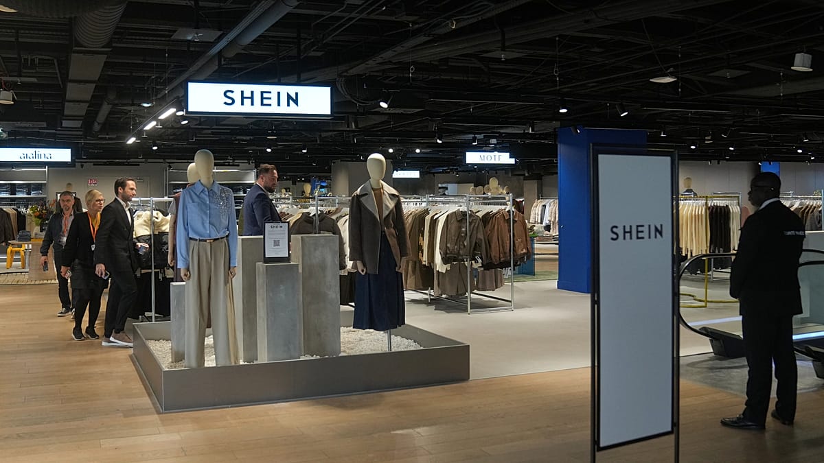 Protesters hold signs against fast fashion