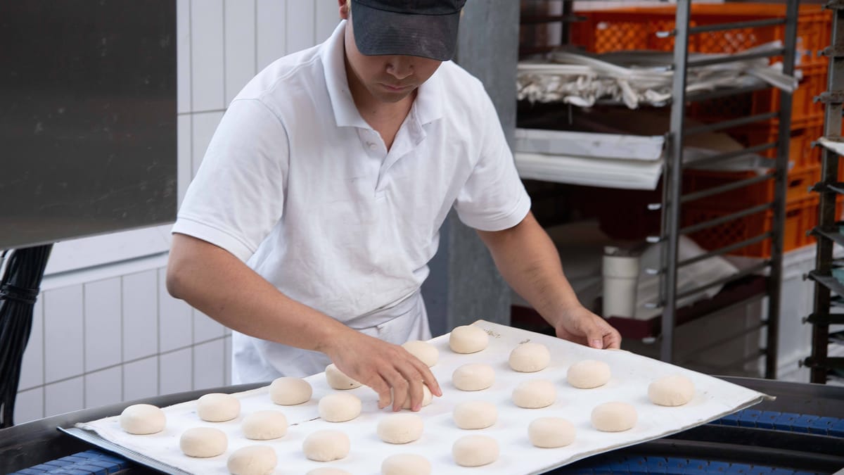 Baker preparing dough for pretzel rolls