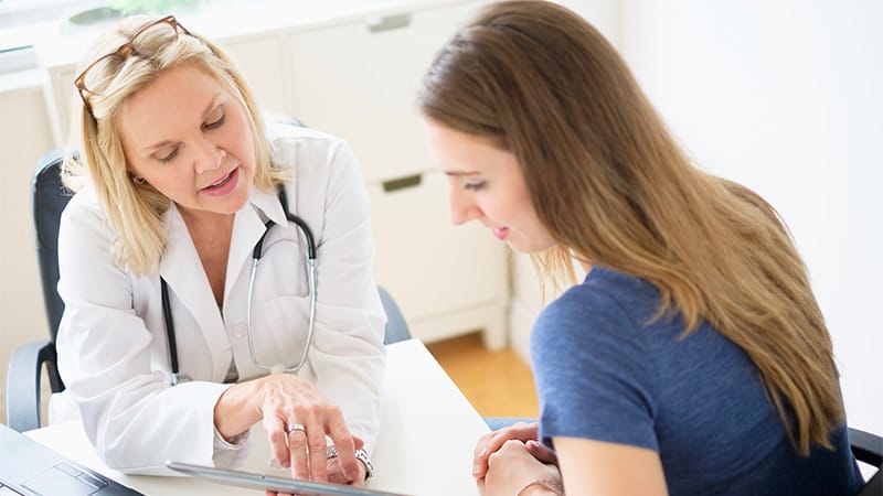 Woman consulting with doctor about reproductive health