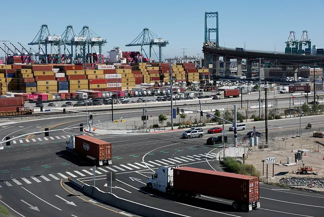 Container ships docked at a busy port terminal illustrating high dwell times