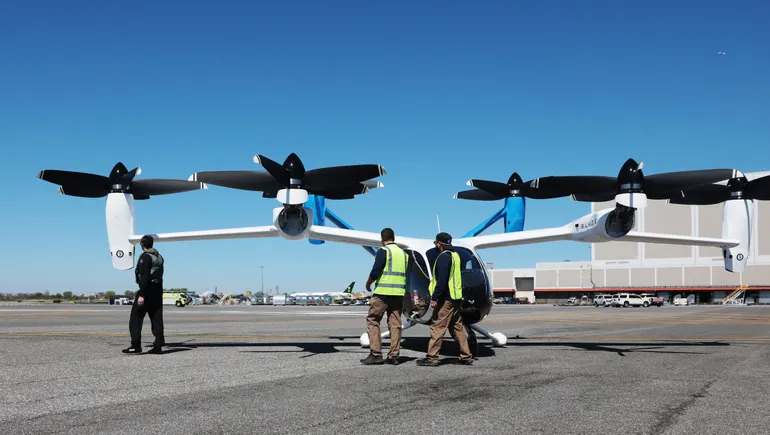 Air taxi concept aircraft in flight over a city