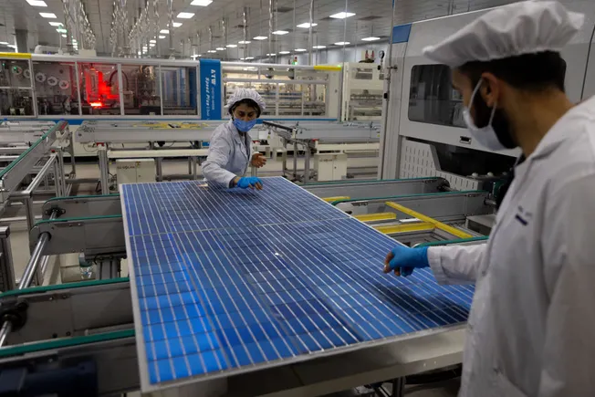 Employees working at a solar technology factory
