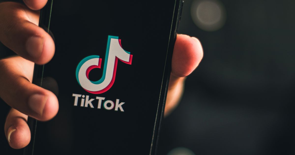 TikTok app icon with Alabama settlement terms displayed
