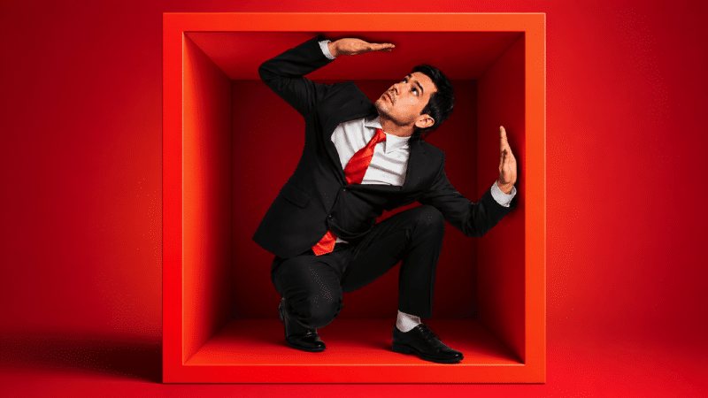 Illustration of a marketer trying to break out of a box