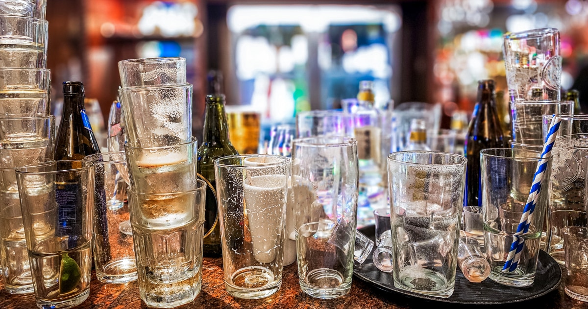 Bar drinks and glasses on a bar counter, illustrating declining alcohol consumption