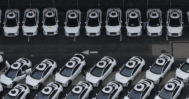 Approximately 50 Waymo robotaxis circling a residential cul-de-sac in northwest Atlanta
