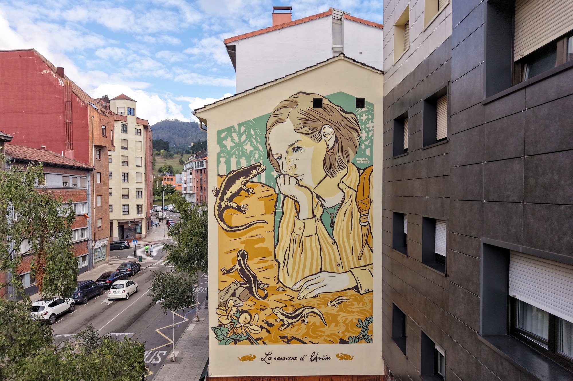 Three murals painted for Parees Festival 2026 in Oviedo, with Greta von Richthofen's work visible in the frame