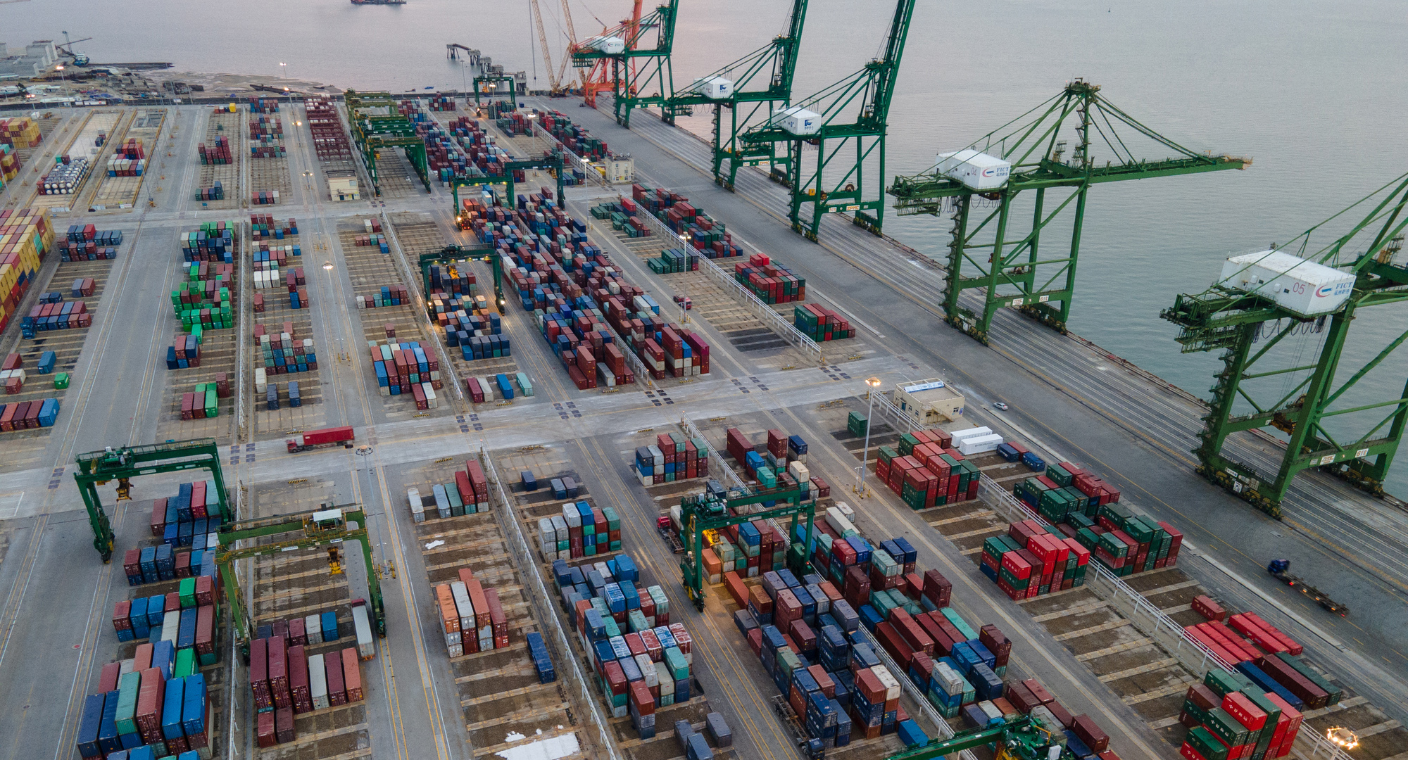 Cargo ships at sea during busy shipping season with containerized cargo visible on deck