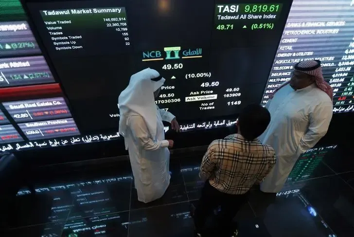 Investors monitoring screens at Saudi Stock Exchange