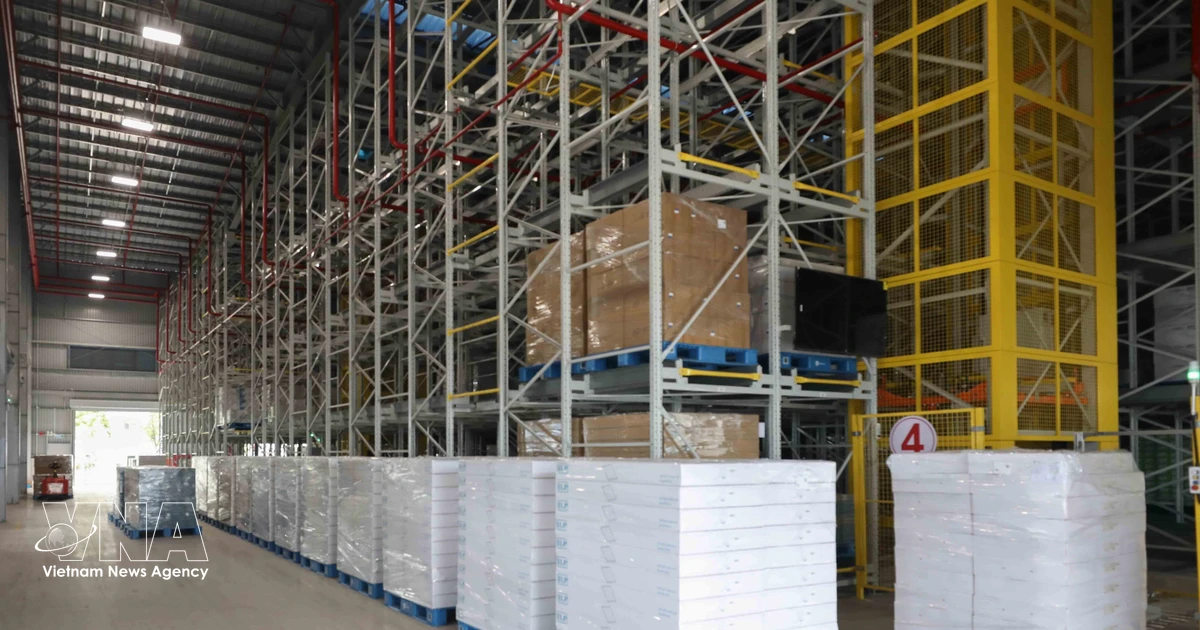High-tech manufacturing facility with workers assembling electronics components