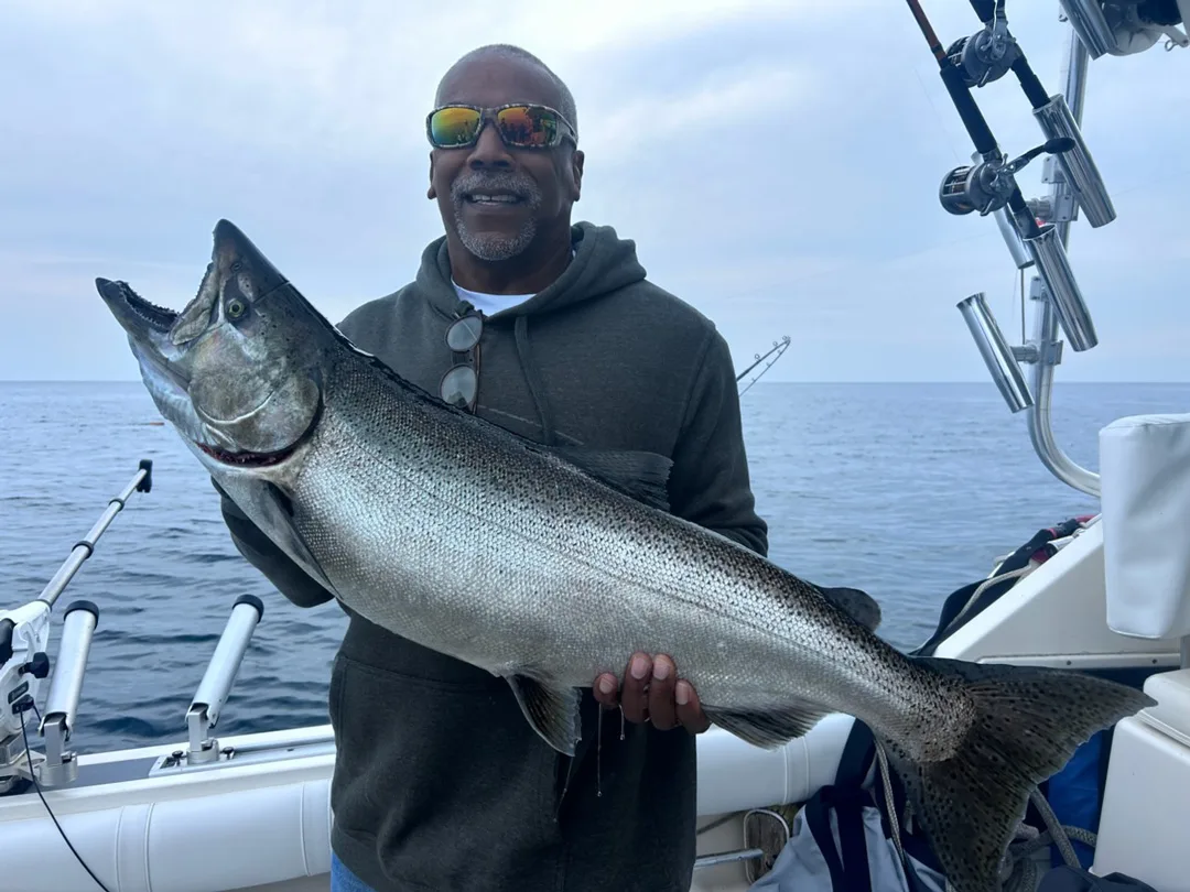 Angler holding a salmon in New York waters