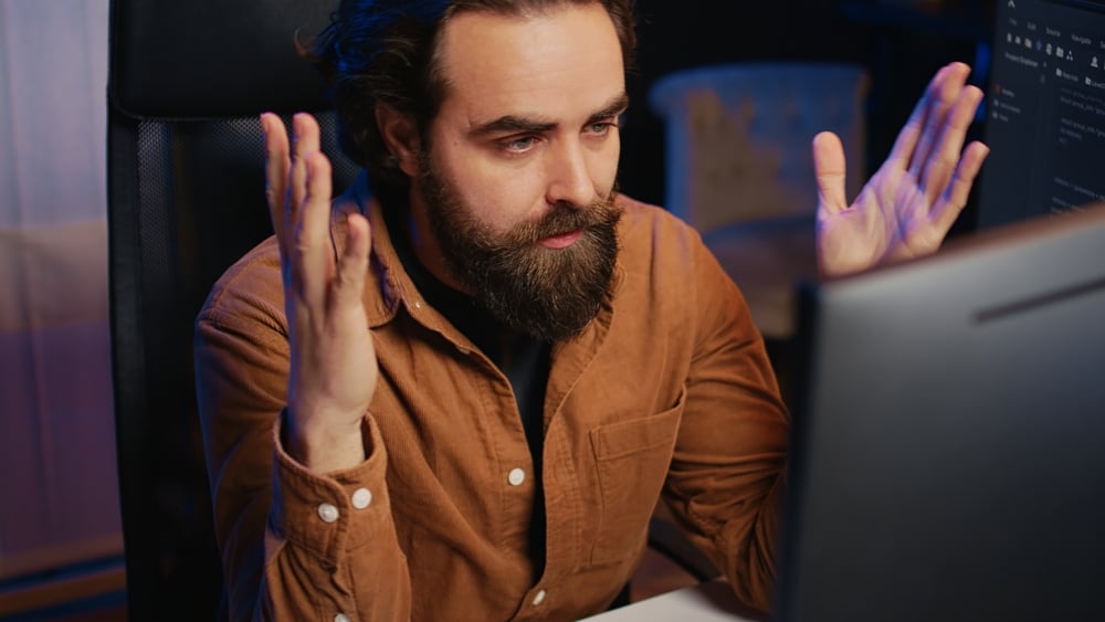 Screenshot of the confused developer image used by The Register to illustrate Visual Studio 18.5's controversial AI debugging paywall