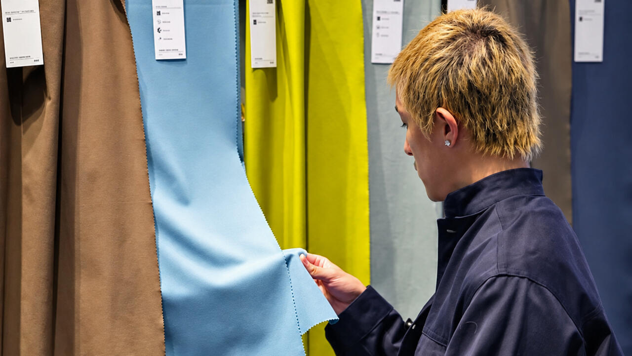 Première Vision exhibition hall image from RFI coverage of sustainable textile materials