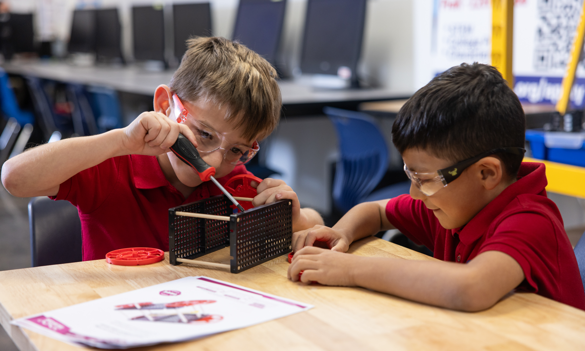 Students working with aquatic robots and drones in hands-on STEM learning