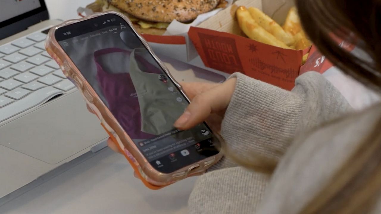 TikTok phone displaying the app interface