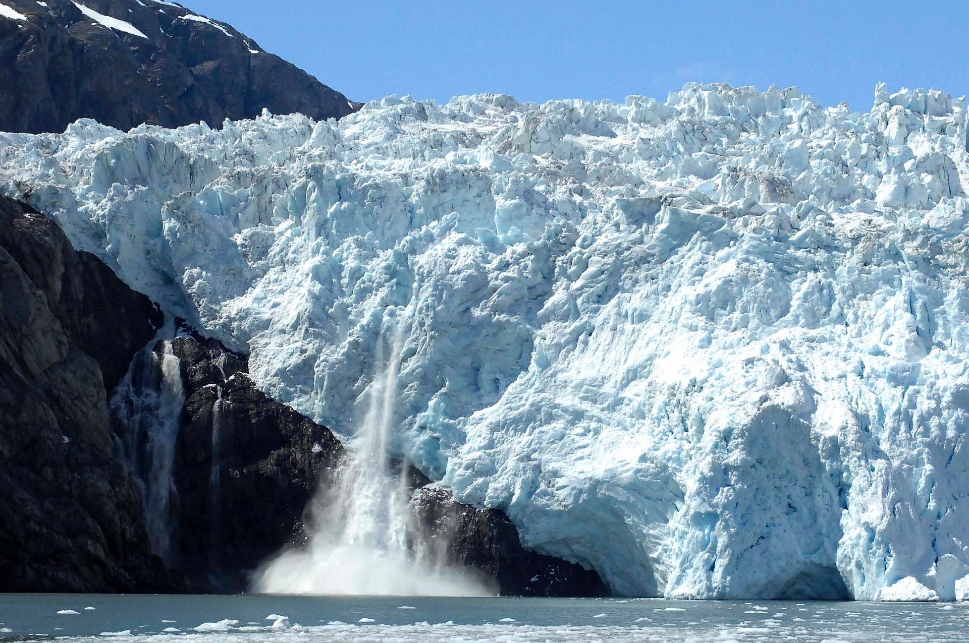 Melting glacier illustrating the disparity in research focus between well-studied ice sheets and neglected permafrost systems