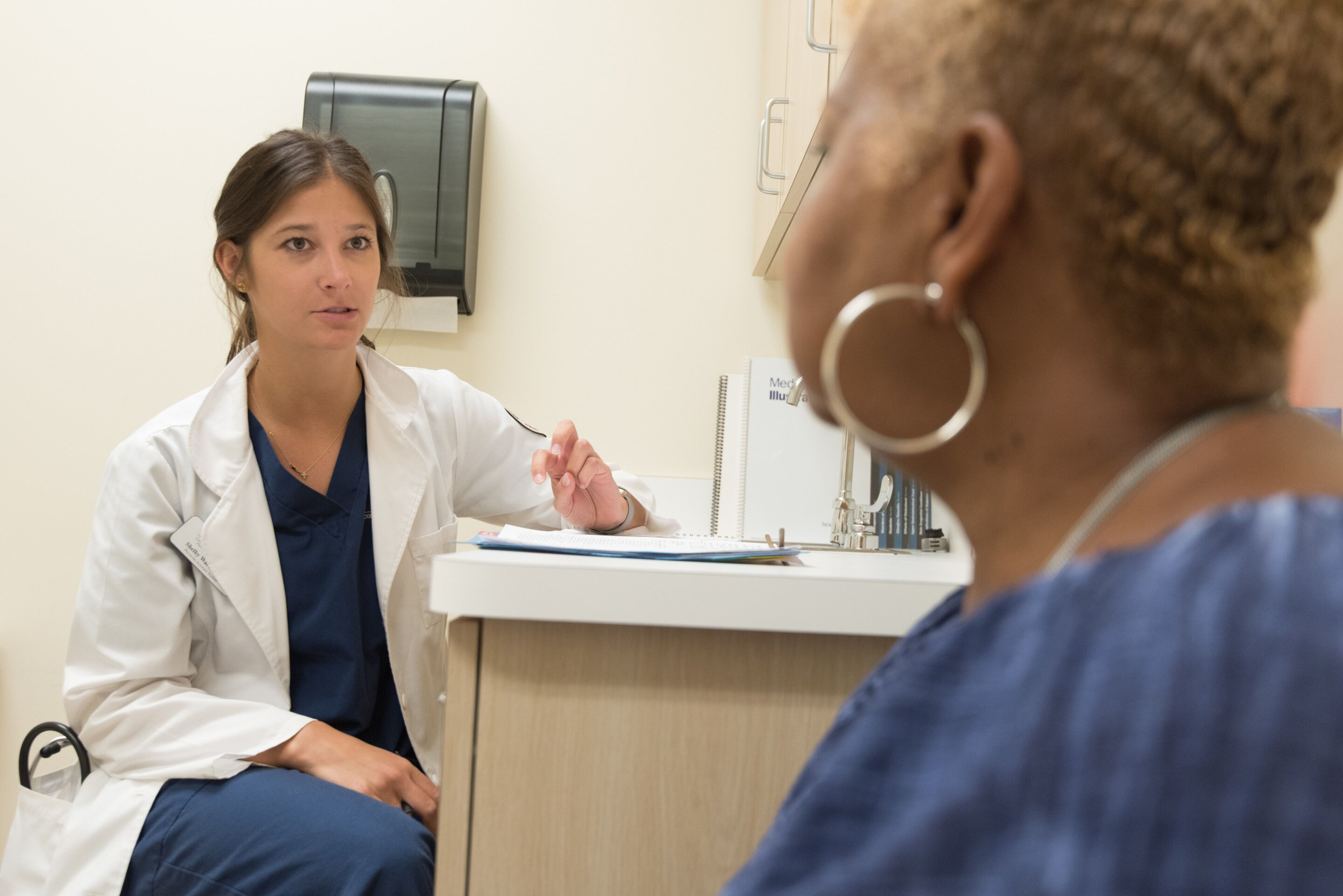 Healthcare provider consulting with diverse patients