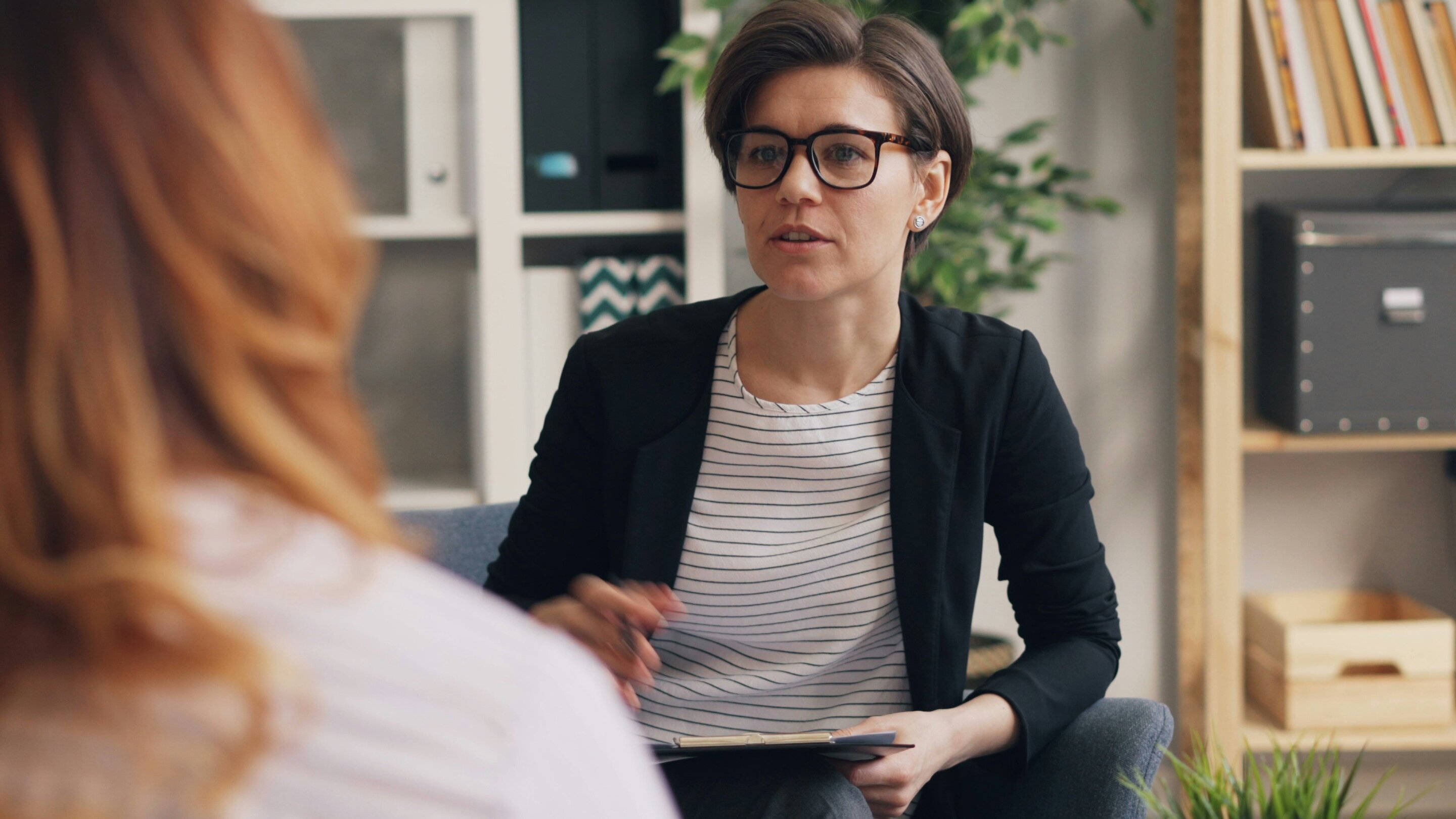 Healthcare professionals providing therapy to a patient, representing integrated mental health care approaches